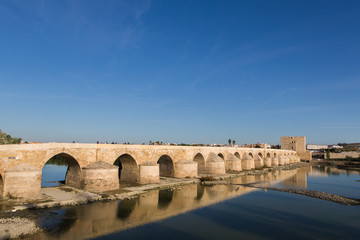 Fototapeta na wymiar Roman bridge across the Guadalquivir river, built in the early 1st century BC in the Historic center of Cordoba, Andalusia, South of Spain 