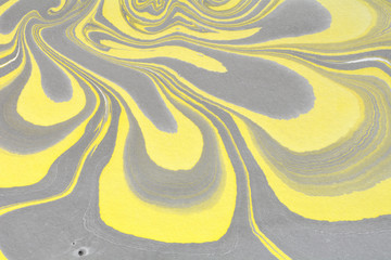 Yellow liquid ink. Creative artistic design. Ebru abstract illustration. Marbling texture. Decorative background. Flowing acrylic paints. Ebru art. Traditional Turkish technique.