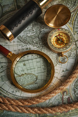 Fototapeta na wymiar Magnifying glass, compass, telescope and map
