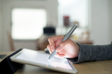 Woman using pen drafting on tablet