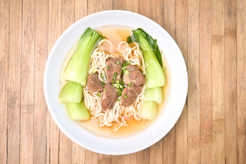 Ramen with Pork and Bok Choy, Pak Choi Cabbage on wood backgroun