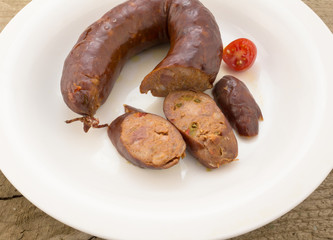 Chorizo sausage and slices on white plate