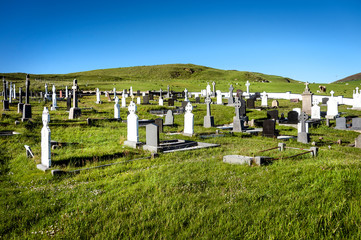 Ireland: Old graveyard with tombstones and Celtic crosses on Malin Head, Ireland