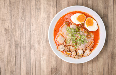 Spicy Tom Yum, Creamy Pork Ramen with egg and mushroom on wood b