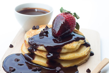 Pancakes with chocolate syrup and strawberry