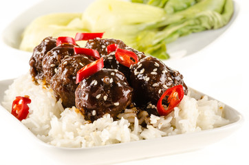 Asian meatballs with chinese sauce served with rice, steamed bok
