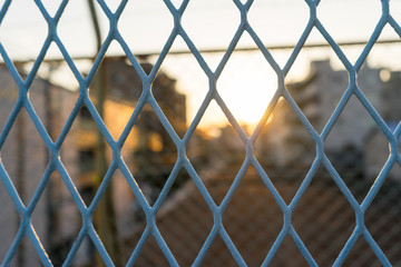 Evening sunbeam through blue fence