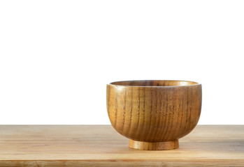 A wooden bowl on a table with isolated background