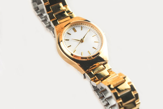 selective focus luxury gold women wrist watch on white background