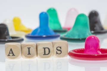 colorful condoms with words stop aids