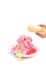 Shaved ice with condensed milk on white background