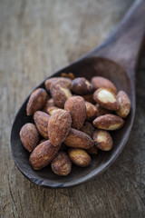 Almond nuts on wooden spoon
