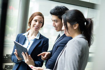 Business team discuss on digital tablet