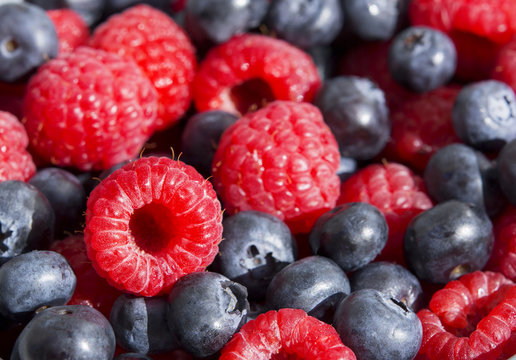 Dessert, fresh berries close-up. The texture of berries, raspberries and blue-berries, macro shot.