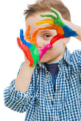 happy child with their hands all painted playing
