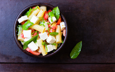 Italian food. Salad with pasta, vegetables and cheese. Top view