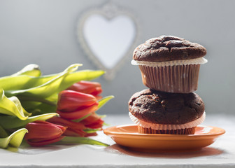 Two chocolate chip muffins and tulips