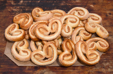 Puff sweet pretzels with cinnamon  on the wooden background