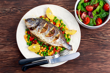 Sea bream baked with herbs and lemon, vegetable mix. 