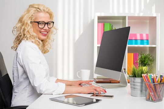 Woman working in the office on stationary computer