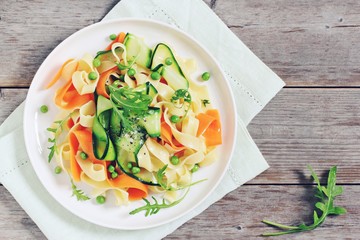 Spring pasta with zucchini ,carrots,green pea and arugula. Healthy eating.Selective focus