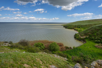 Fototapeta na wymiar Lake shore view with cloudy sky