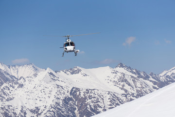 Fototapeta na wymiar White rescue helicopter in the mountains