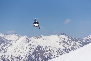 White rescue helicopter  in the mountains