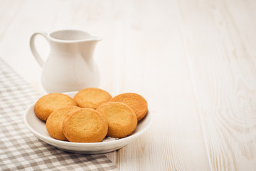 Biscuits on a white, wooden table with cloth