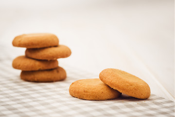 Biscuits on a white, wooden table with cloth