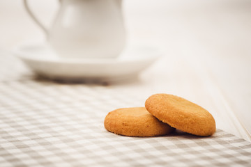 Biscuits on a white, wooden table with cloth