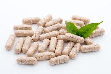 Ginkgo biloba capsule on the white background.