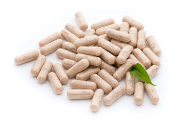 Ginkgo biloba capsule on the white background.