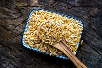 Organic Kamut grain on wooden background