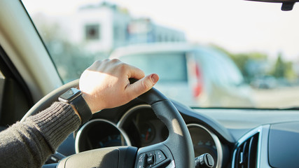 Close-up Of A Man Hands Holding Steering Wheel While Driving Car