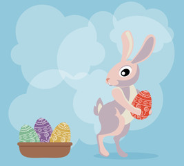 Bunny with egg in his paws, looking at the basket with Easter eg