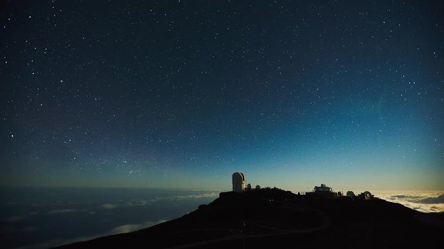 Star time lapse, milky way galaxy moving across the night sky above observatory