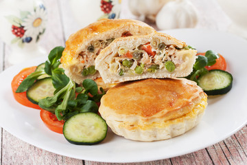 Mini pie with chicken meat and vegetables