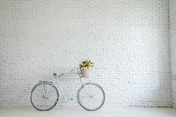 Retro bicycle on roadside with vintage brick wall background,