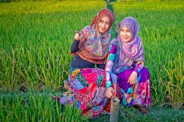 Muslim woman playing on paddy field in a village at Indonesia