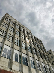 abandoned industrial building under dramatic sky