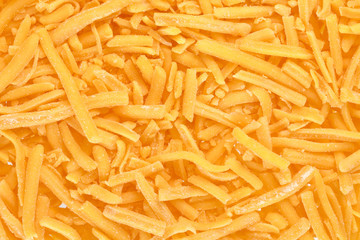 close up image grated cheddar cheese