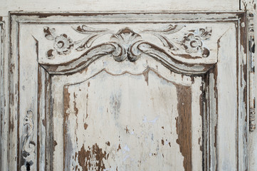 Close-up of ancient white commode bureau furniture with paint peeled off 