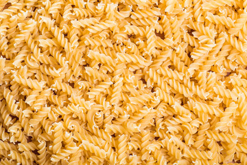 Spiral pasta scattered form background 