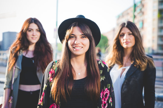 Portrait of three young women in city