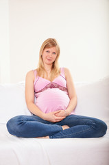 Pregnant woman relaxing at home on the couch