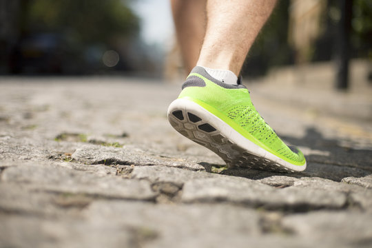 Runner jogging on cobbled street
