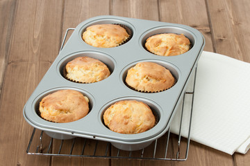 Homemade Cheddar Muffins In Baking Tray. Wooden Table.
