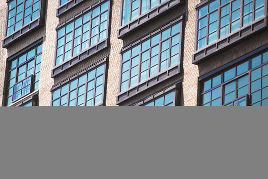 Detail of apartment windows of old industrial building, Manhattan, New York, USA
