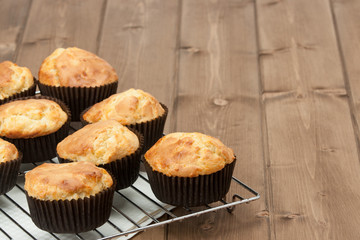 Homemade Cheddar Muffins In Paper Cases. Wooden Table.